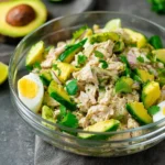 Avocado tuna salad in a bowl with fresh ingredients
