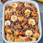 Delicious banana bread pudding served in a white dish with a sprinkle of cinnamon