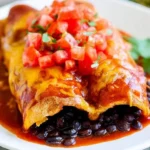 Delicious black bean enchiladas topped with cheese and fresh cilantro