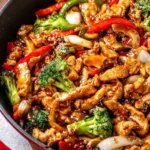 Delicious black pepper chicken served with steamed vegetables and rice