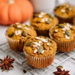 Blender pumpkin oat muffins topped with pumpkin seeds and yogurt