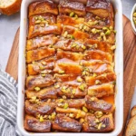 Delicious Brioche French Toast Casserole topped with fresh berries and maple syrup