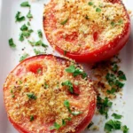 Broiled tomatoes topped with Parmesan cheese, freshly baked and golden brown.