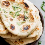 Delicious Greek yogurt naan bread served warm with herbs and spices