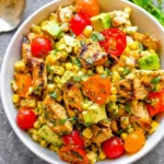 Grilled chicken salad with fresh corn, vibrant greens, and a light dressing