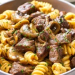 Instant Pot Beef Stroganoff dish with tender beef and creamy sauce over pasta