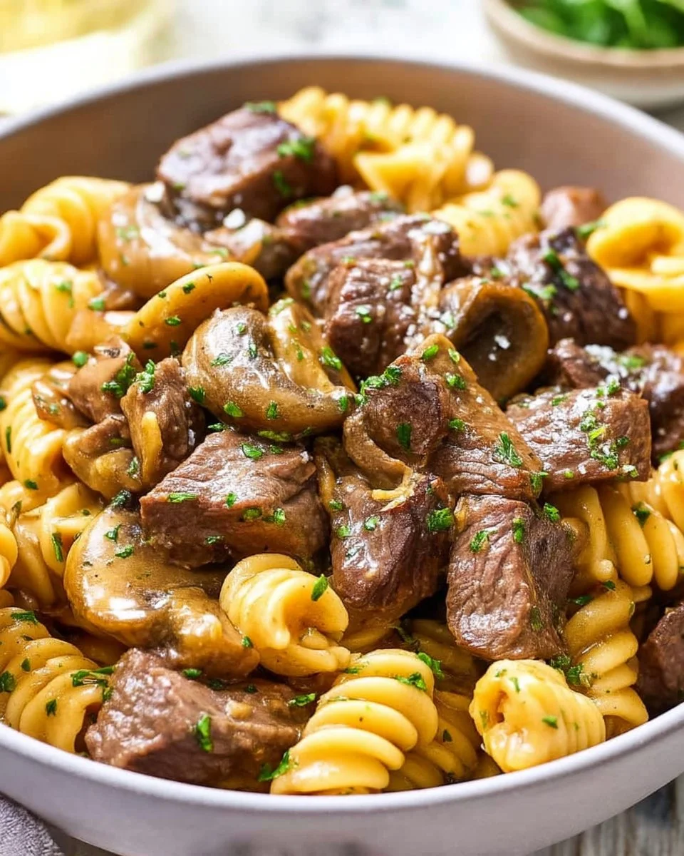 Instant Pot Beef Stroganoff dish with tender beef and creamy sauce over pasta