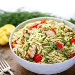 Lemon Dill Chicken served with Orzo Pasta Salad garnished with fresh herbs