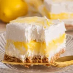 Delicious slice of Lemon Lush dessert with lemon filling and creamy topping.