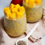 Delicious Mango Chia Pudding topped with fresh mango slices and mint.