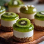 Mini kiwi cheesecake topped with fresh kiwi slices and a creamy filling.