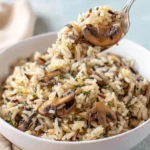 Delicious Mushroom Rice Pilaf served in a bowl with fresh herbs.