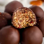 Delicious homemade pecan pie balls rolled in pecans and chocolate