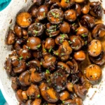 Delicious sautéed mushrooms dish served on a plate with herbs