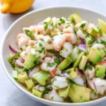 Delicious shrimp ceviche served in a fresh lime marinade with vegetables.