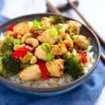 Spicy chicken stir fry with colorful vegetables in a skillet