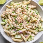 Bowl of colorful Tuna Pasta Salad with vegetables and dressing