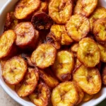 Crispy air fryer banana chips served in a bowl.