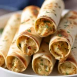 Baked chicken taquitos served with salsa and avocado slices