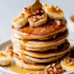 Delicious Banana Foster Pancakes topped with caramelized bananas and whipped cream