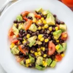 Colorful Black Bean Corn Avocado Salad with Cumin Lime Vinaigrette in a bowl