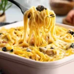 Cheesy chicken spaghetti served in a bowl with fresh herbs garnish
