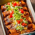 Delicious Chicken Mole Enchiladas topped with rich mole sauce and cheese
