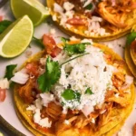 Delicious Chicken Tinga Toasts topped with fresh ingredients and served warm.