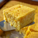 Deliciously baked corn casserole in a serving dish, perfect for large gatherings.