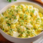 Bowl of cottage cheese egg salad garnished with herbs and spices