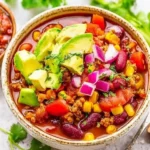 Bowl of easy 30-minute taco soup topped with cheese and cilantro