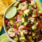 Bowl of easy avocado shrimp ceviche with fresh ingredients and vibrant colors.