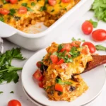 Easy chicken enchilada casserole topped with cheese and cilantro