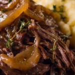 Delicious French Onion Pot Roast served with melted cheese and herbs