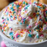 Delicious Funfetti Dip served in a bowl with colorful sprinkles