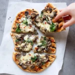 Grilled flatbread pizza topped with fresh vegetables and cheese