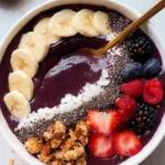 High-protein acai bowl topped with fruits and seeds for a nutritious meal.