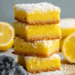 Delicious Keto Lemon Bars on a white plate garnished with lemon zest