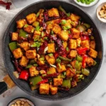 Delicious Kung Pao Tofu stir-fry with vegetables and peanuts on a plate