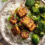 Delicious lemon pepper tofu served on a plate garnished with herbs