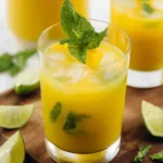 Refreshing Mango Mojito cocktail garnished with mint and lime
