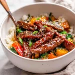 Mongolian Beef Stir Fry Bowl with tender beef and colorful vegetables