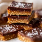 Delicious no bake millionaire bars topped with chocolate and caramel.