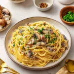 Delicious bowl of Pasta Carbonara topped with parmesan and pepper.