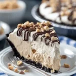 Delicious Peanut Butter Ice Cream Pie topped with chocolate and peanuts