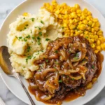 Slow cooker cube steak dish with vegetables and gravy.