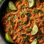 Slow Cooker Mexican Shredded Chicken served in a bowl with toppings.