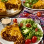 Delicious homemade Taco Pie served on a plate with toppings