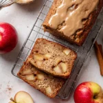 Freshly baked Apple Cake Loaf with slices on a wooden plate