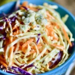 Delicious blue cheese coleslaw served in a bowl with vegetables